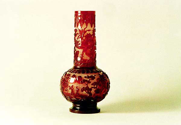 Glass vase with landscape and figure design in transparent red overlay on snowflake white ground