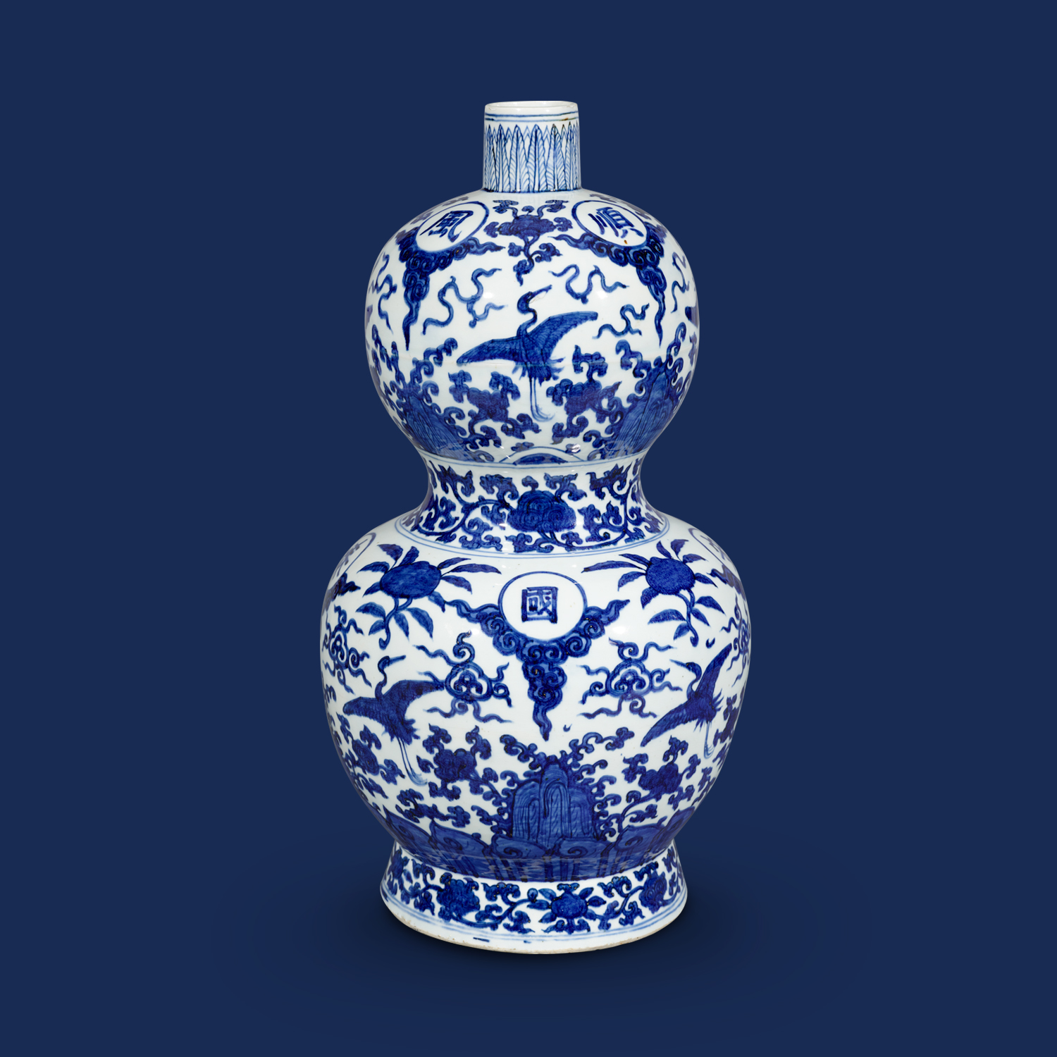Double-gourd vase inscribed with <i>fengtiao yushun guotai min'an</i> blessings in underglaze blue