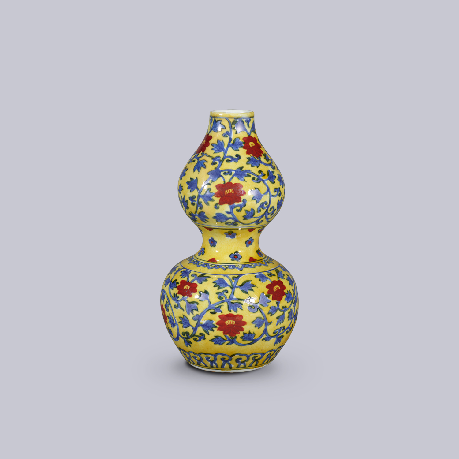 Double-gourd vase with iron-red interlocking floral scrolls design in underglaze blue on yellow ground