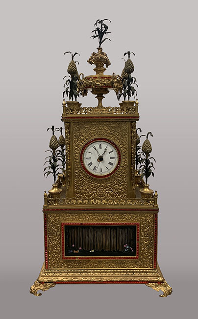 Gilt bronze clock with enamel and coloured glass inlay and waterfall features
