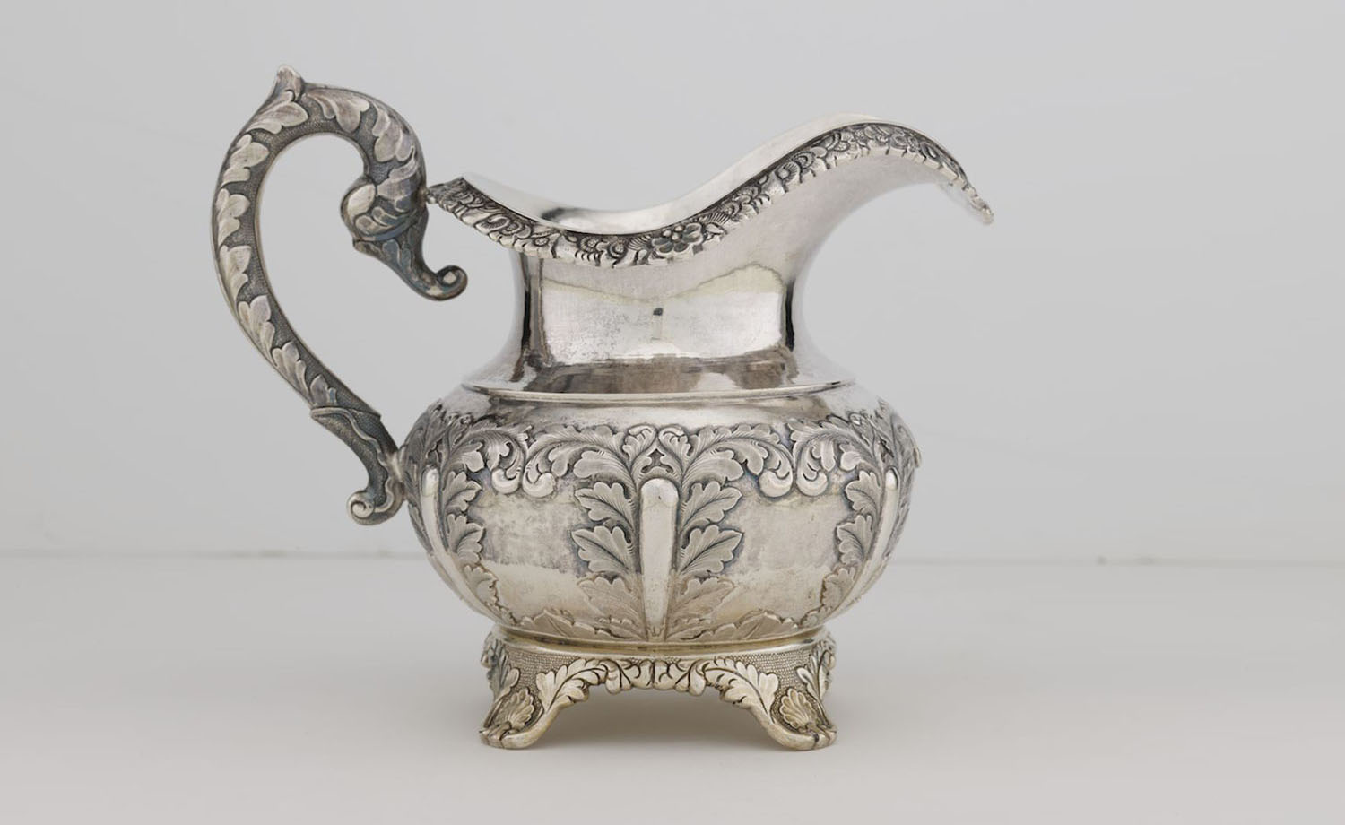 Silver cream jug decorated with acanthus leaf pattern<br> Cutshing, Canton<br>Mark of "CUT" and pseudo hallmarks