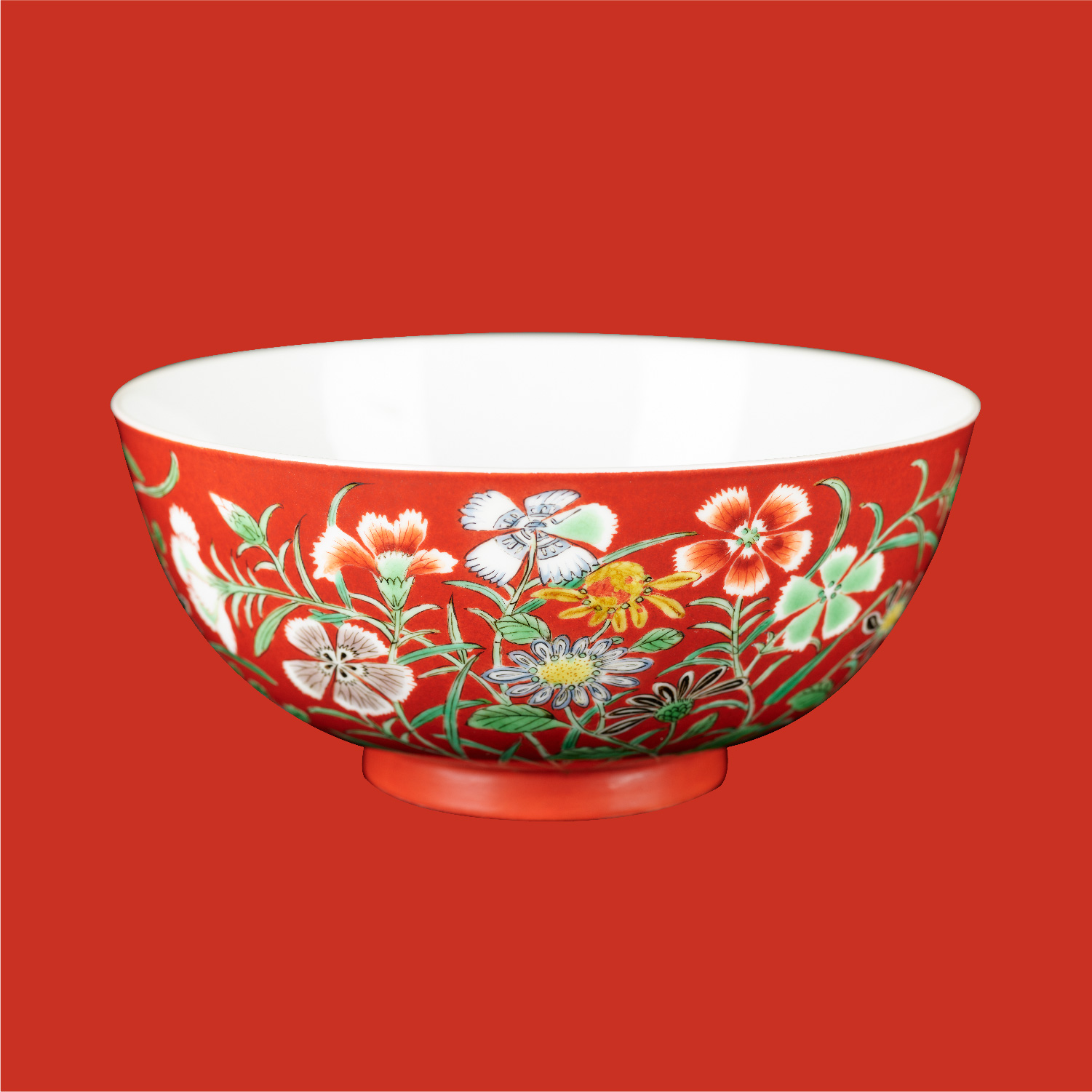 Bowl with floral design in <em>wucai</em> enamels on coral red ground