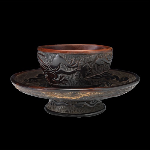 Carved black lacquer cupstand with dragon amidst cloud and wave design